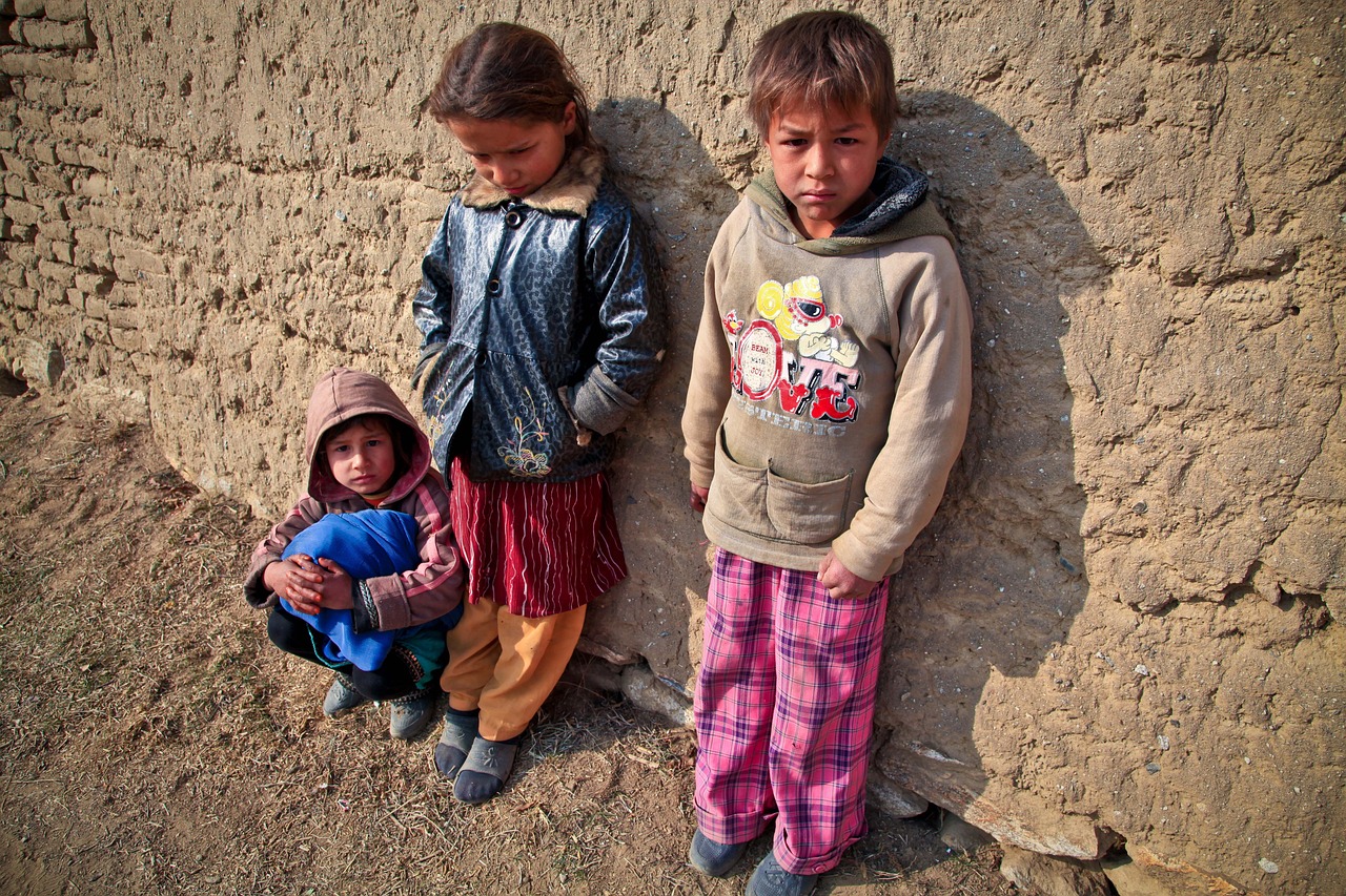 two young children standing next to a stone wall, flickr, dau-al-set, afghan girl, three dwarf brothers, !! low contrast!!, warm sunshine