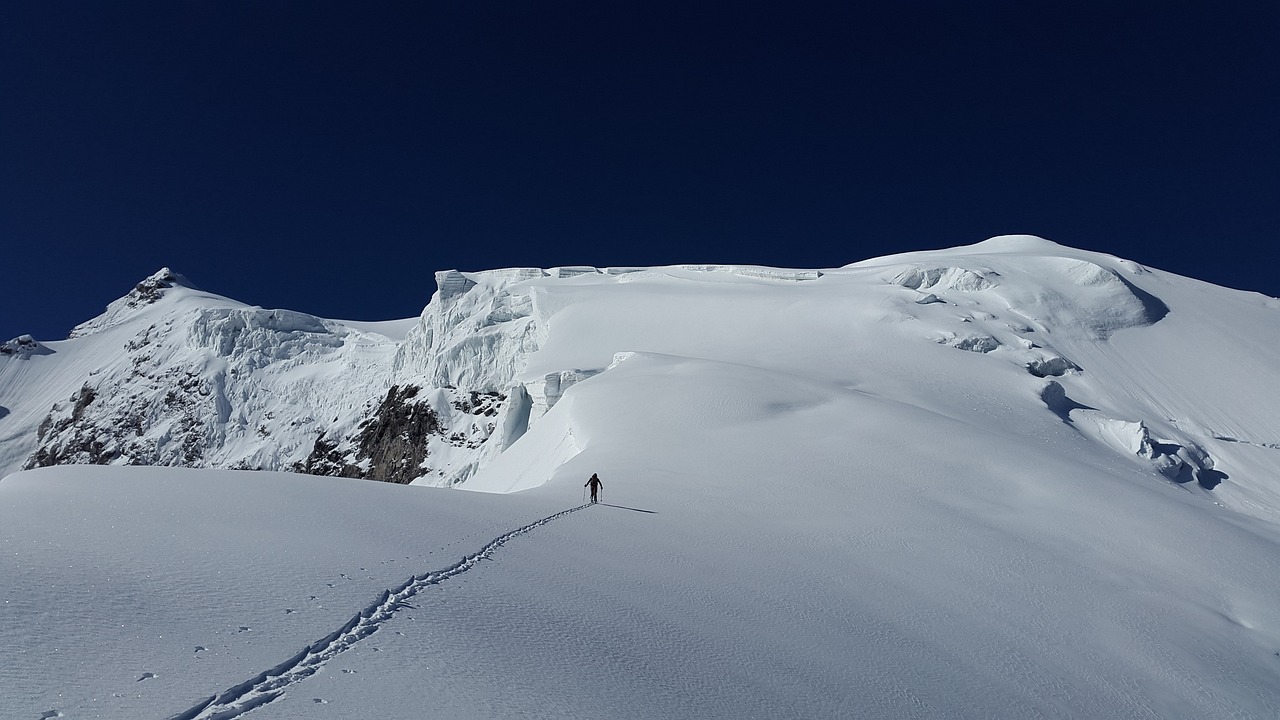 a person walking up the side of a snow covered mountain, a photo, les nabis, andes, amanda clarke, skidding, adventure