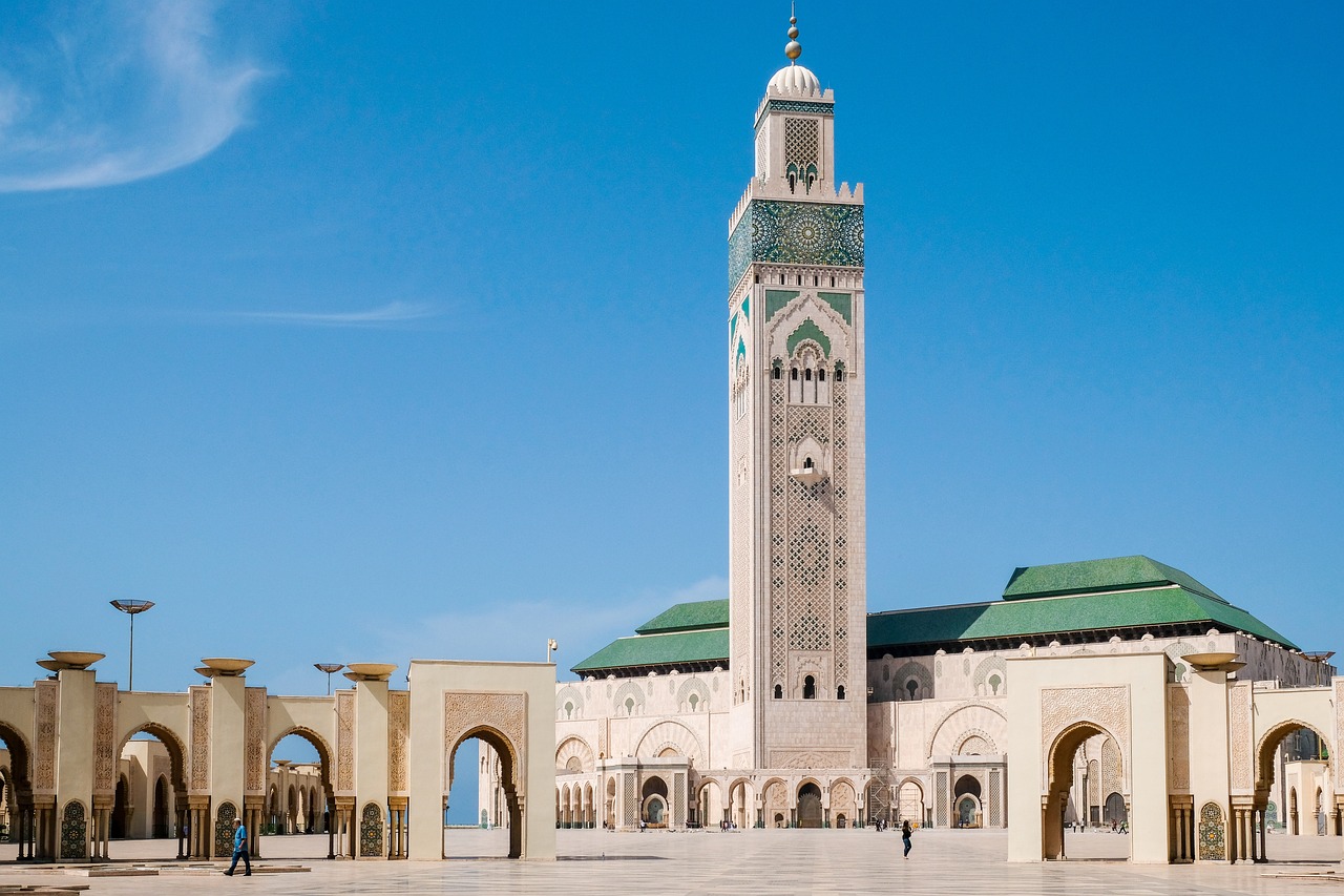 a large white building with a clock tower, inspired by Alberto Morrocco, shutterstock, arabesque, moroccan mosque, panorama, hero shot, burka