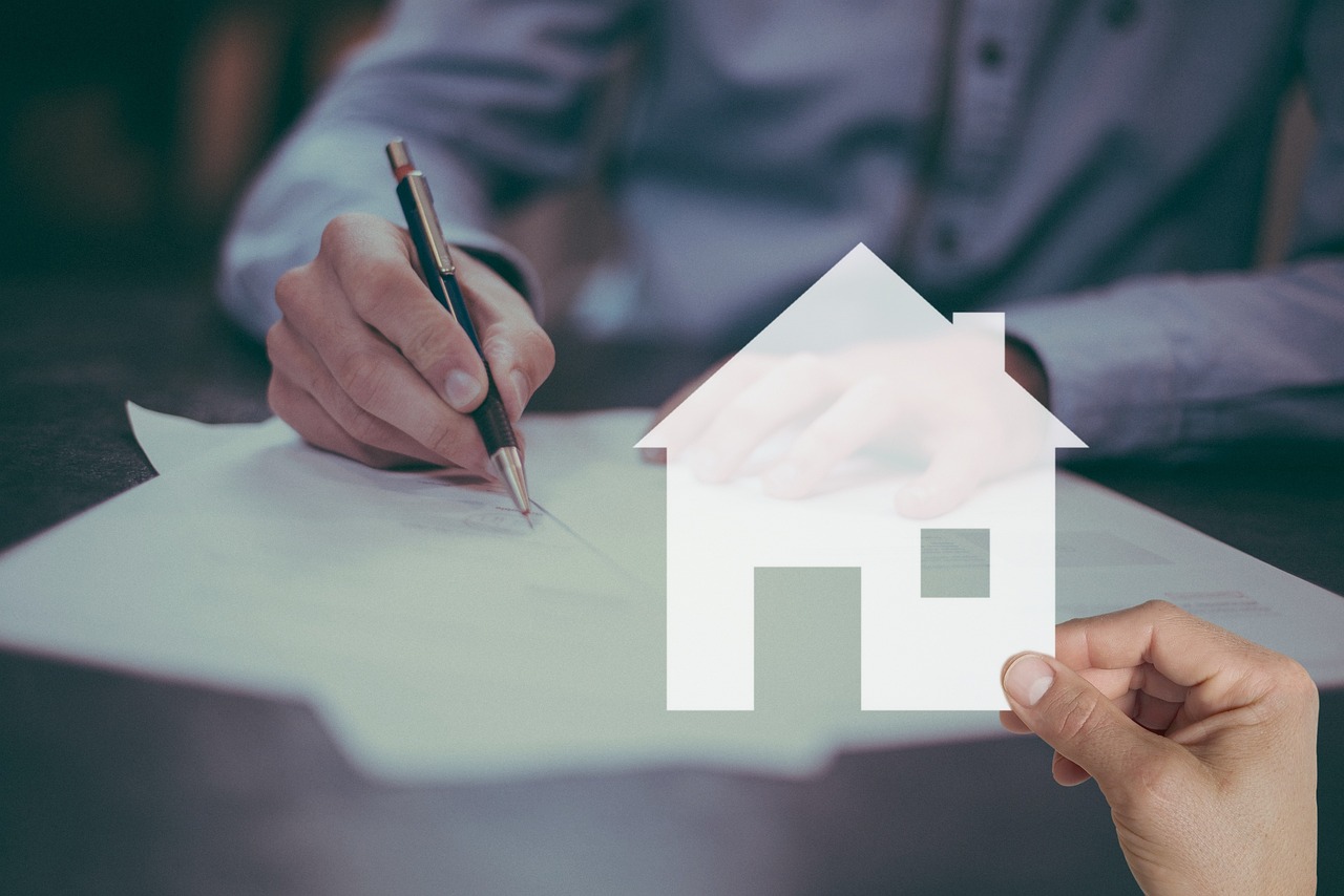 a person holding a pen and writing on a piece of paper, a digital rendering, people looking at a house, selling insurance, listing image, hand on table