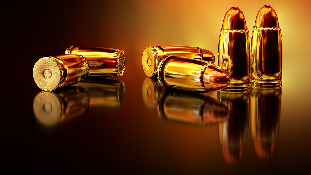 a couple of bullet shells sitting on top of a table, digital art, pixabay, digital art, golden glow, tanks, in style of ultra realistic, realistic gun design