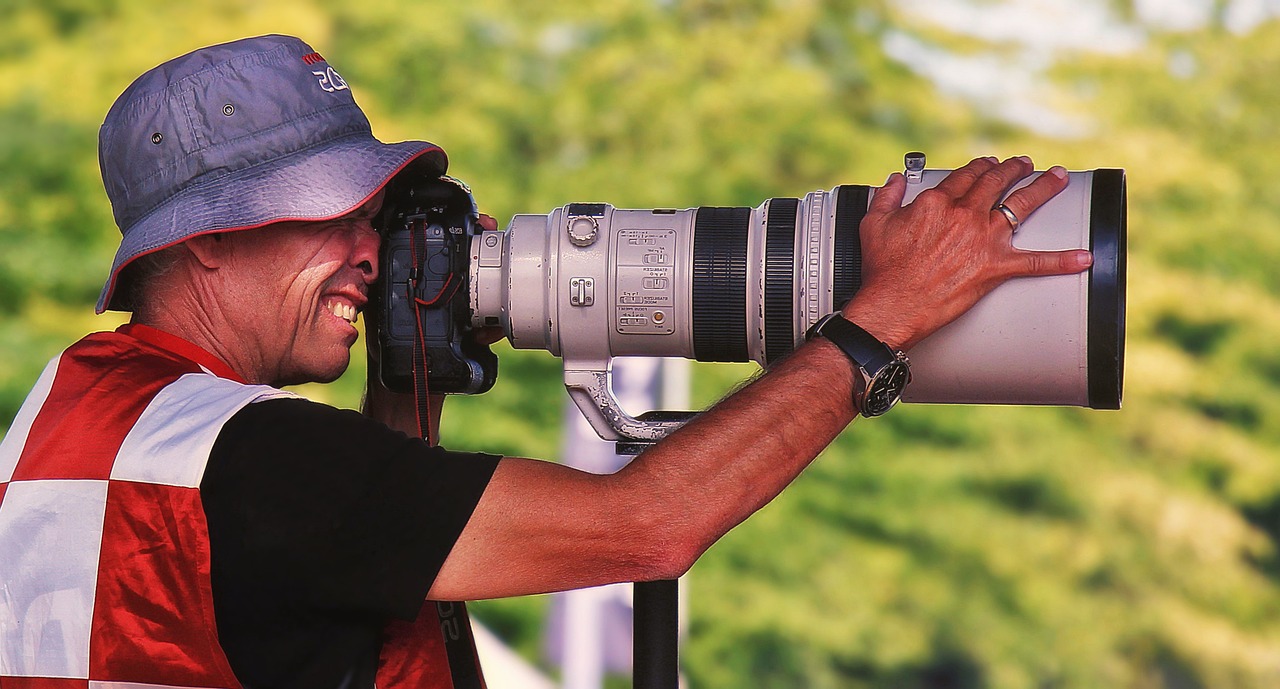 a man taking a picture with a large camera, by Jan Rustem, pexels contest winner, photorealism, sigma 5 0 0 mm f / 5, panoramic photography, sport photography, !! looking at the camera!!