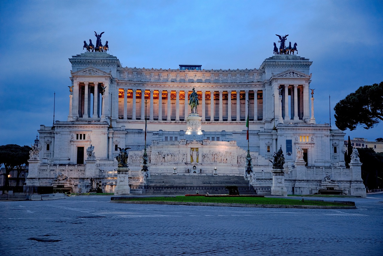 a large white building with statues on top of it, by Carlo Martini, pixabay, all roads lead to rome, blue hour photography, italian flag, stock photo