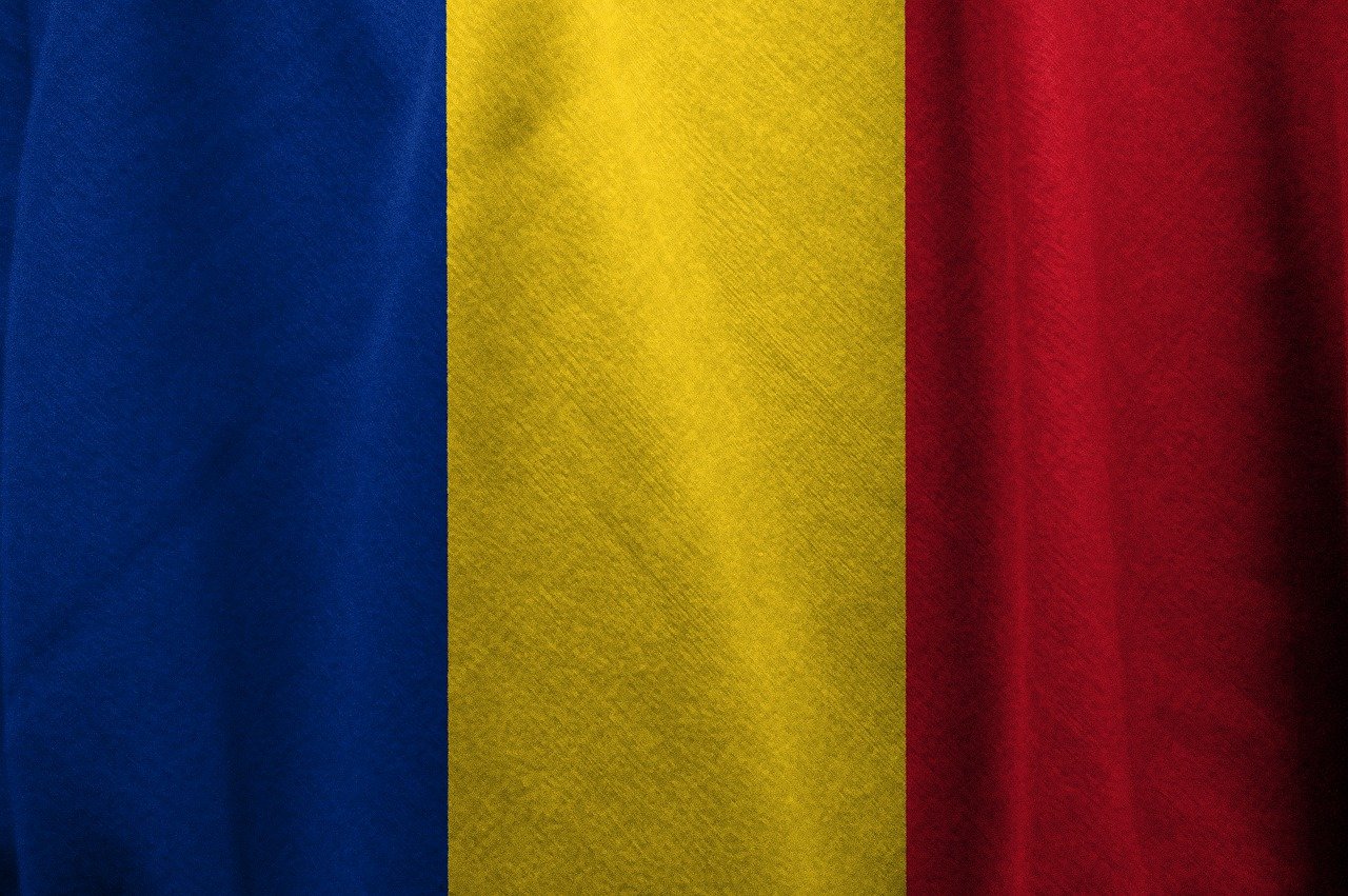 a close up of a red, yellow and blue shirt, inspired by Ștefan Luchian, shutterstock, flag, cotton texture, transylvania, background made of big curtains