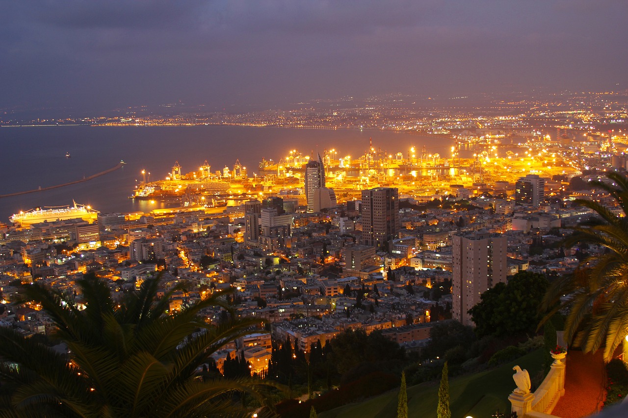 a view of a city at night from the top of a hill, by Emanuel Witz, pexels, renaissance, hebrew, tropical coastal city, istockphoto, terminal