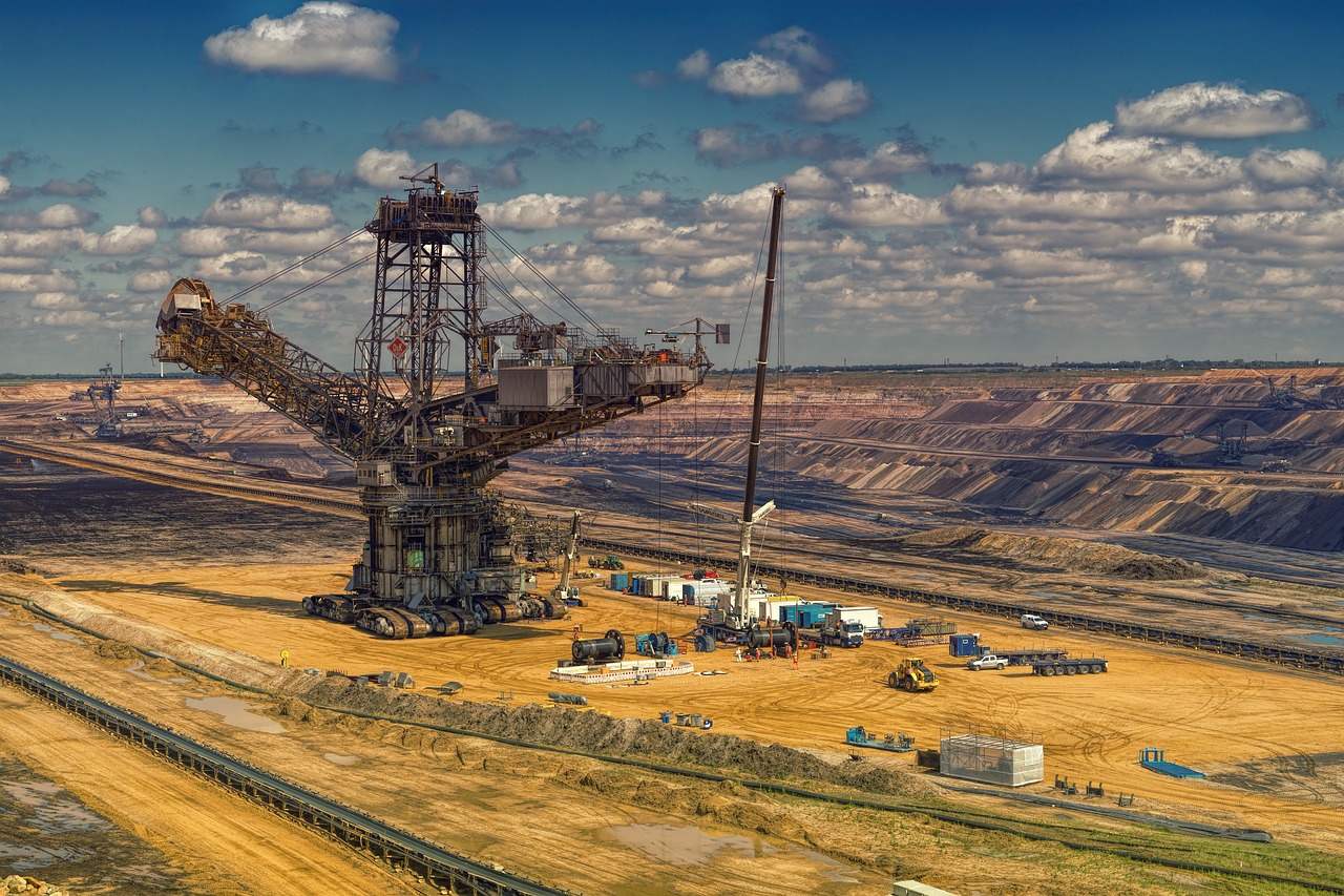a large crane sitting on top of a dirt field, by Werner Gutzeit, pexels contest winner, figuration libre, a beautiful mine, 1128x191 resolution, mechanical superstructure, 8 k. filling of the view