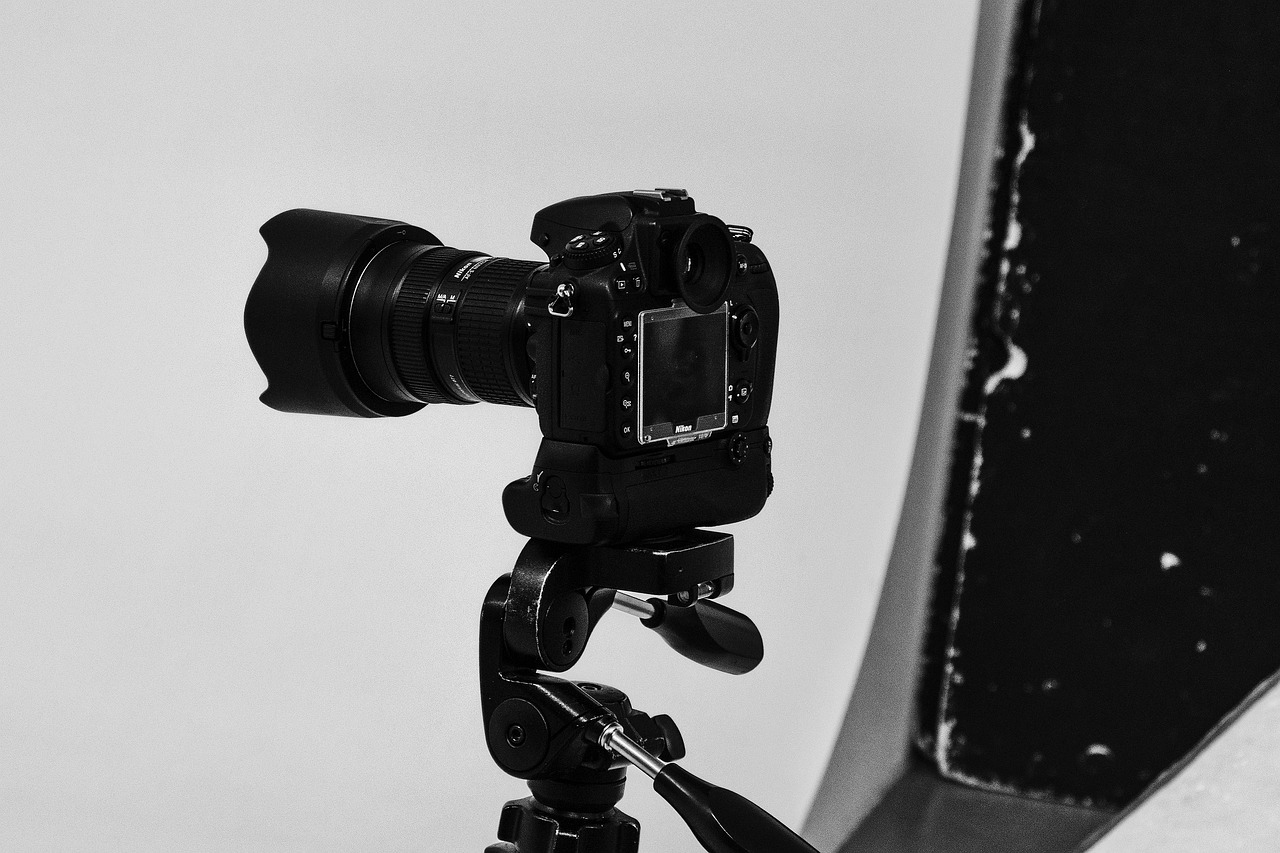 a black and white photo of a camera on a tripod, a black and white photo, soft volumetric studio lighting, head and shoulders 8 0 mm camera, video camera, ecommerce photograph