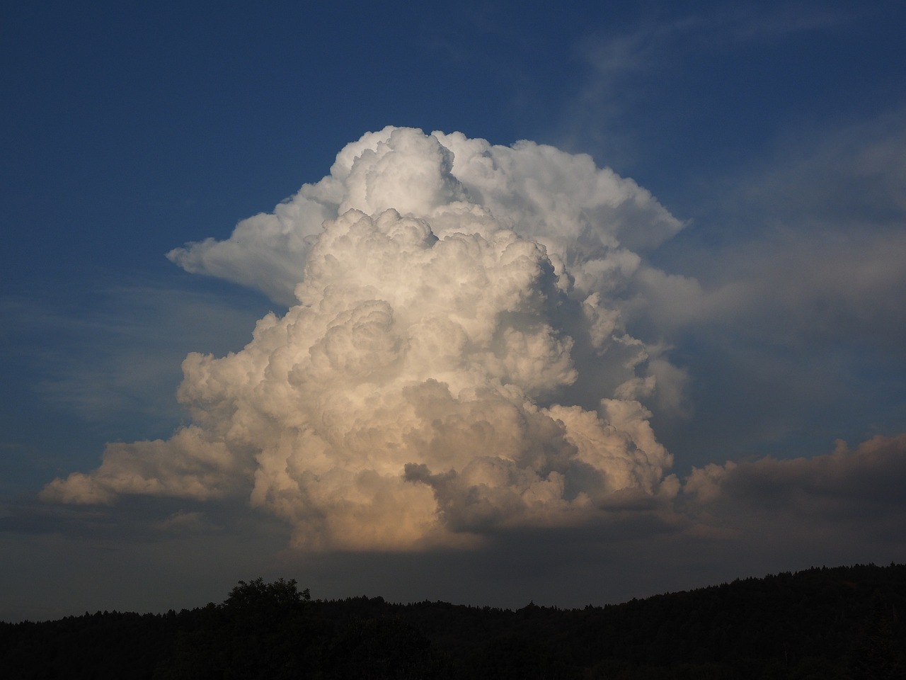 a large cloud in the middle of a blue sky, romanticism, evening storm, hardturm, giant afro!, nice afternoon lighting