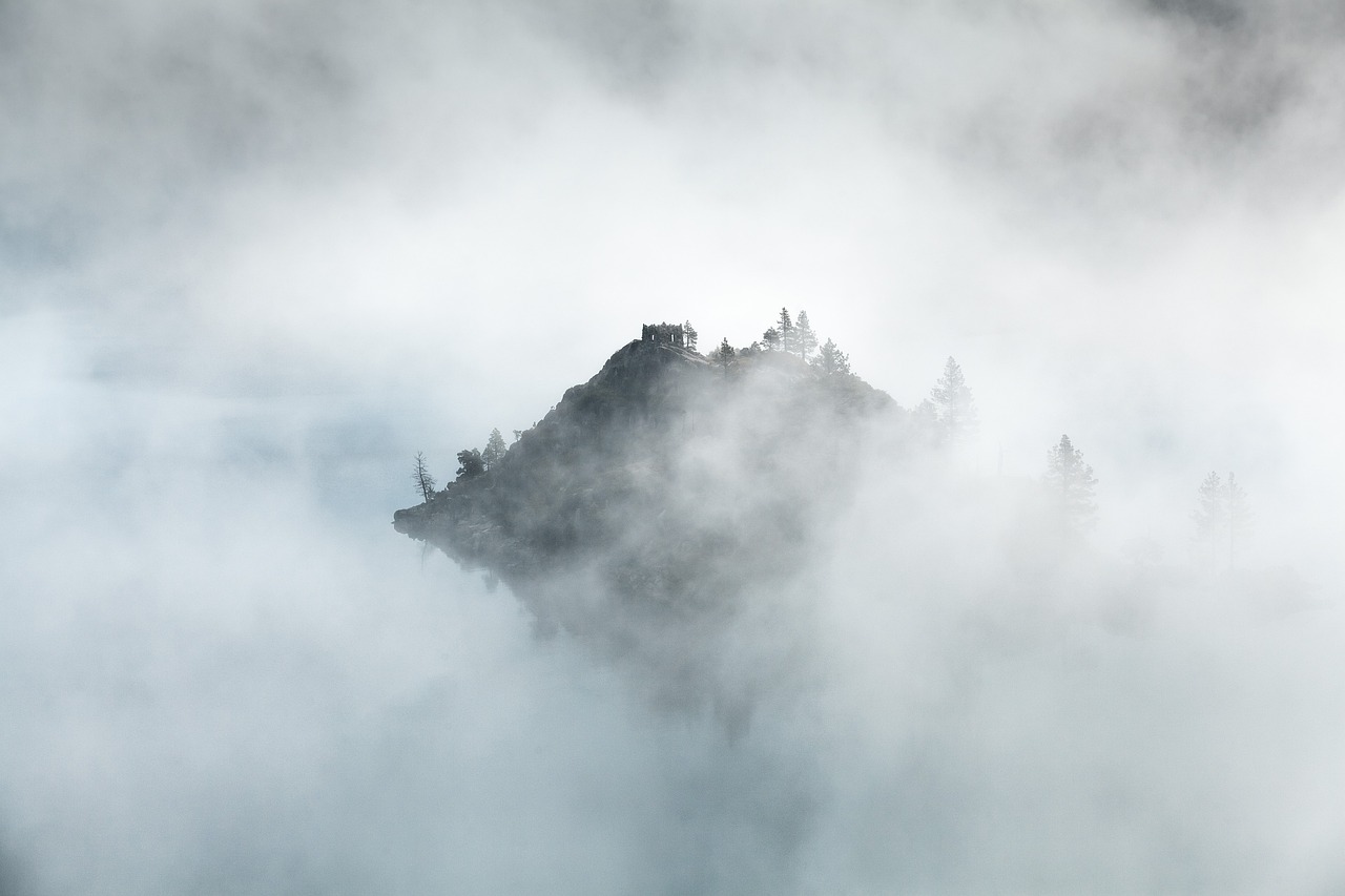 a black and white photo of a mountain in the clouds, a picture, by Matthias Weischer, unsplash contest winner, minimalism, misty castle, california;, floating island, colored fog
