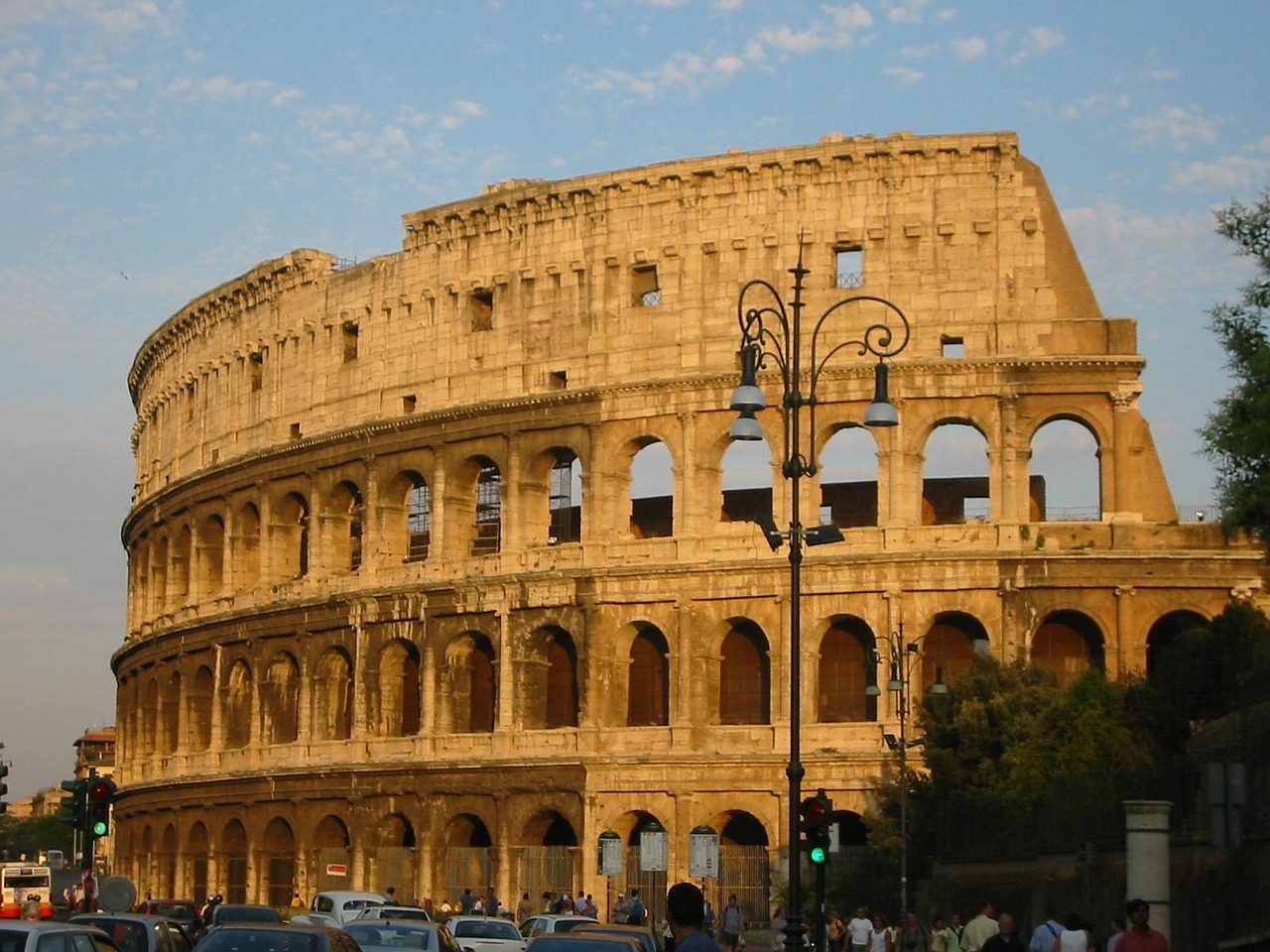 a group of cars that are parked in front of a building, a picture, pexels contest winner, neoclassicism, colosseum, wikimedia commons, side view from afar, warm sunlight shining in