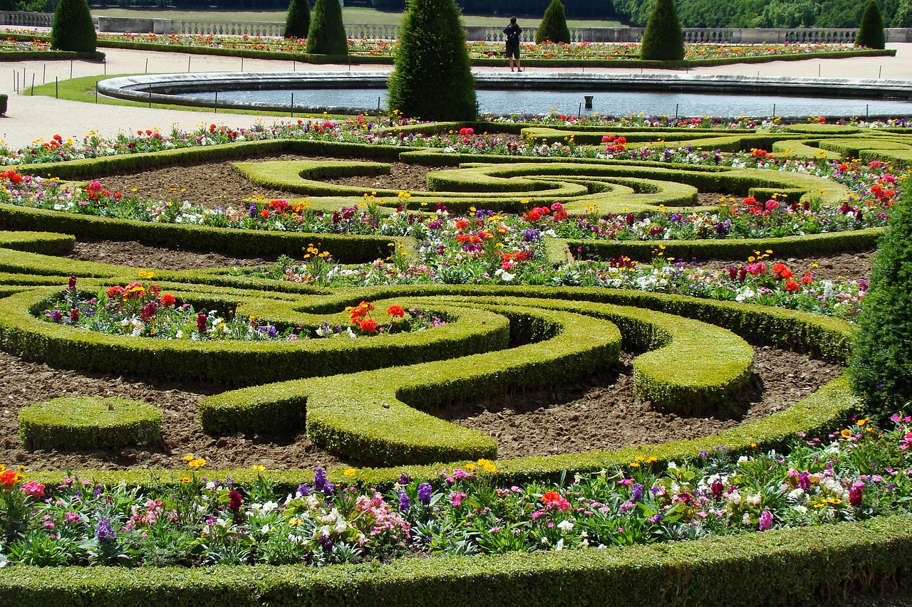 a garden filled with lots of different types of flowers, by Robert Griffier, pixabay, rococo, serpentine maze, chateau de versailles, twisted waterway, rich geometry