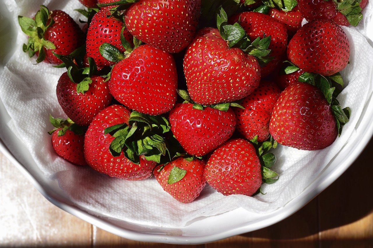 a white bowl filled with lots of ripe strawberries, a photo, photorealism, closeup photo, photorealism. trending on flickr, warm sunshine, modern very sharp photo