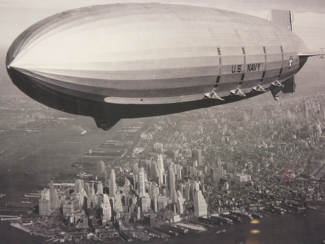 a large air balloon flying over a city, flickr, retrofuturism, new york harbour, documentary photograph, zeppelin, panel