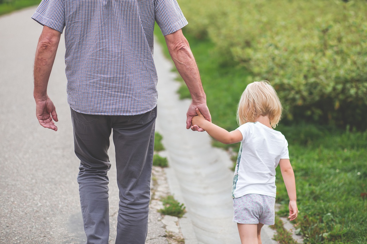 a little boy holding the hand of an older man, by Jesper Knudsen, pexels, man and woman walking together, 🤬 🤮 💕 🎀, daughter, colour corrected
