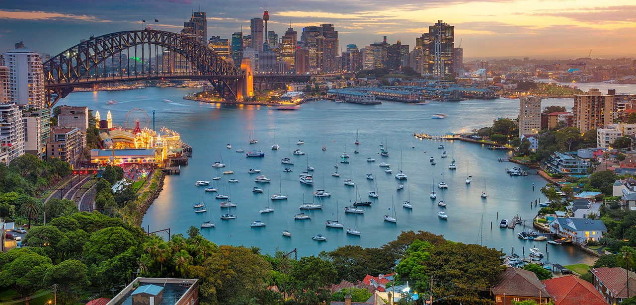 a large body of water filled with lots of boats, inspired by Sydney Carline, shutterstock, city twilight landscape, 4k photo”