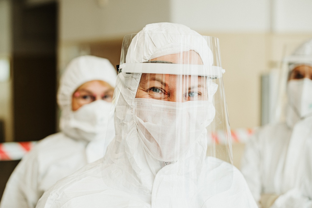 a group of people in protective gear standing next to each other, a picture, by Emma Andijewska, shutterstock, plasticien, full close-up portrait, people look into the frame, beautiful lady, clean room