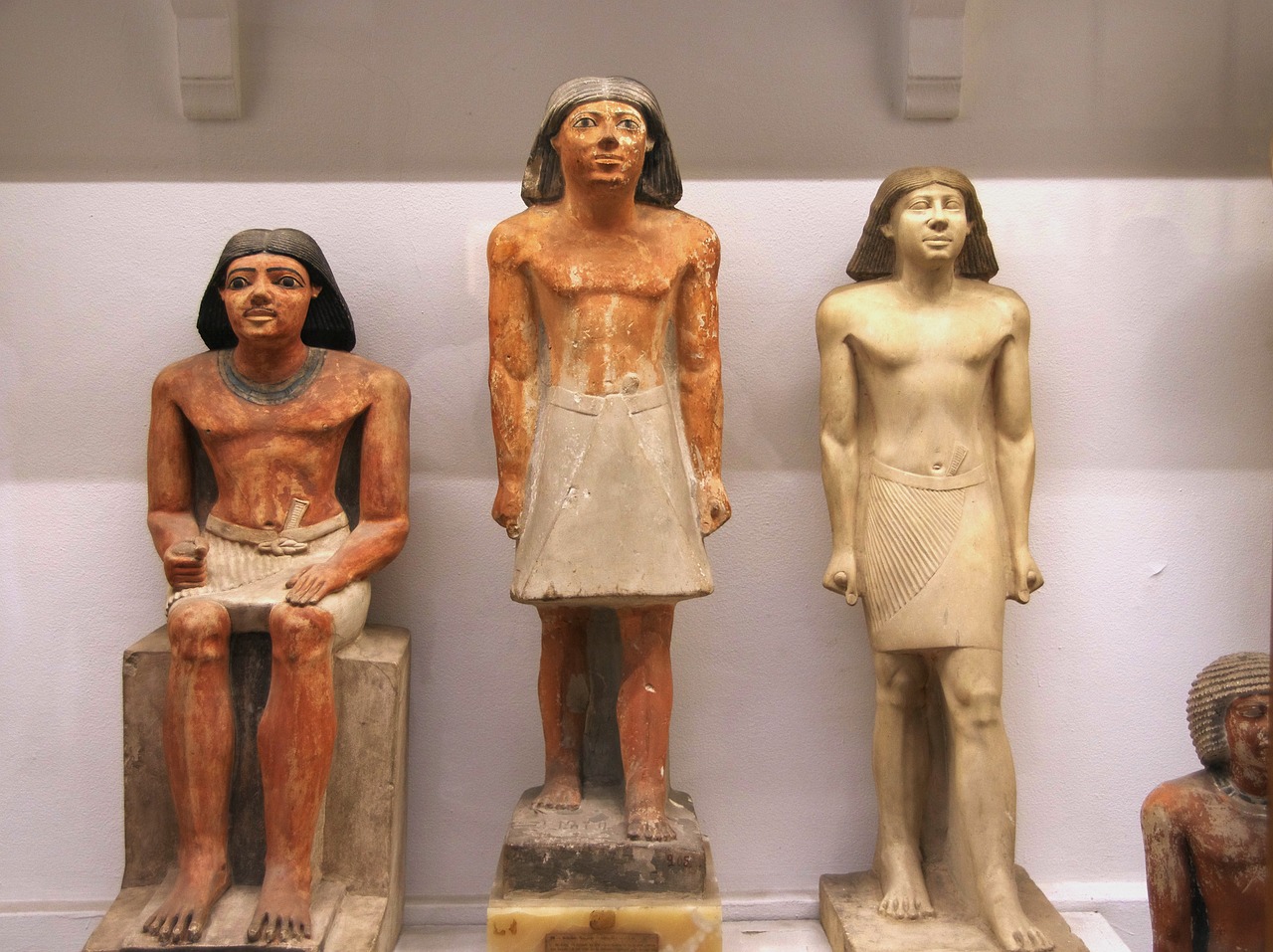 a couple of statues sitting next to each other, egyptian art, by Viktor de Jeney, flickr, slender boy with a pale, two skinny old figures, symmetrical shoulders, coloured