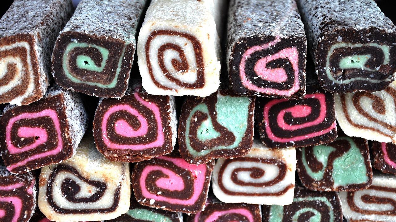 a pile of pastries sitting on top of each other, a pastel, inspired by Władysław Podkowiński, flickr, chocolate candy bar packaging, spirals, closeup!!, licorice allsort filling