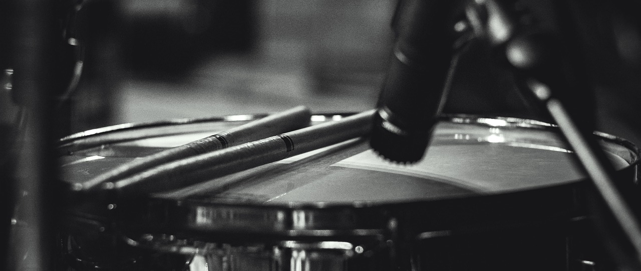 a black and white photo of drums and drumsticks, by Adam Marczyński, unsplash, photorealism, detail shots, pencil, [ [ hyperrealistic ] ], artist unknown