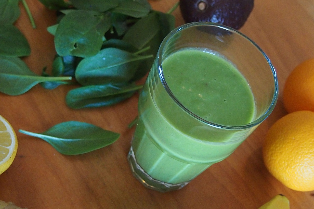 a glass of green juice sitting on top of a wooden table, avocado, ramps, hyperdetailed!, unedited