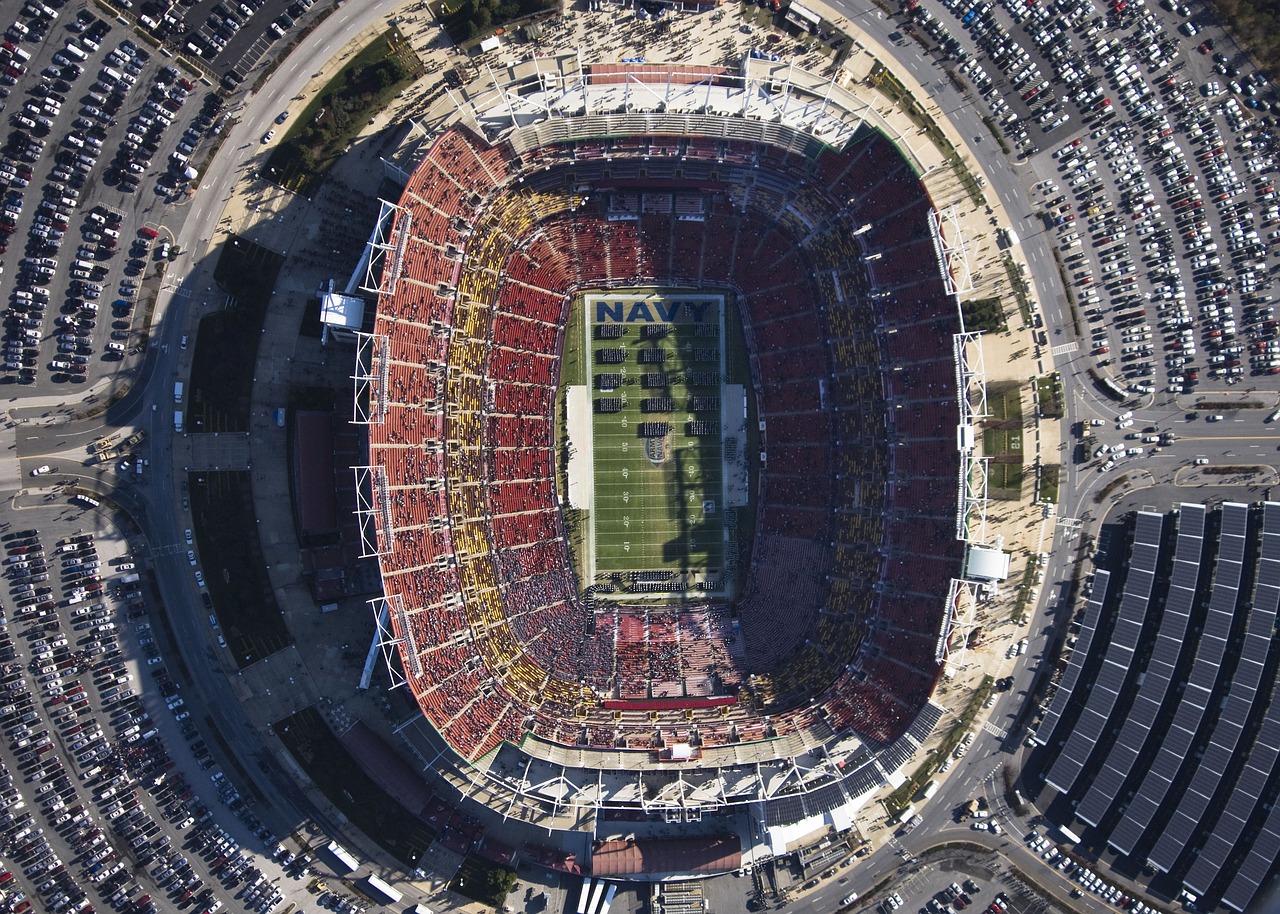 an aerial view of a football stadium, by Jon Coffelt, navy, usa-sep 20, red blue and gold color scheme, sky view