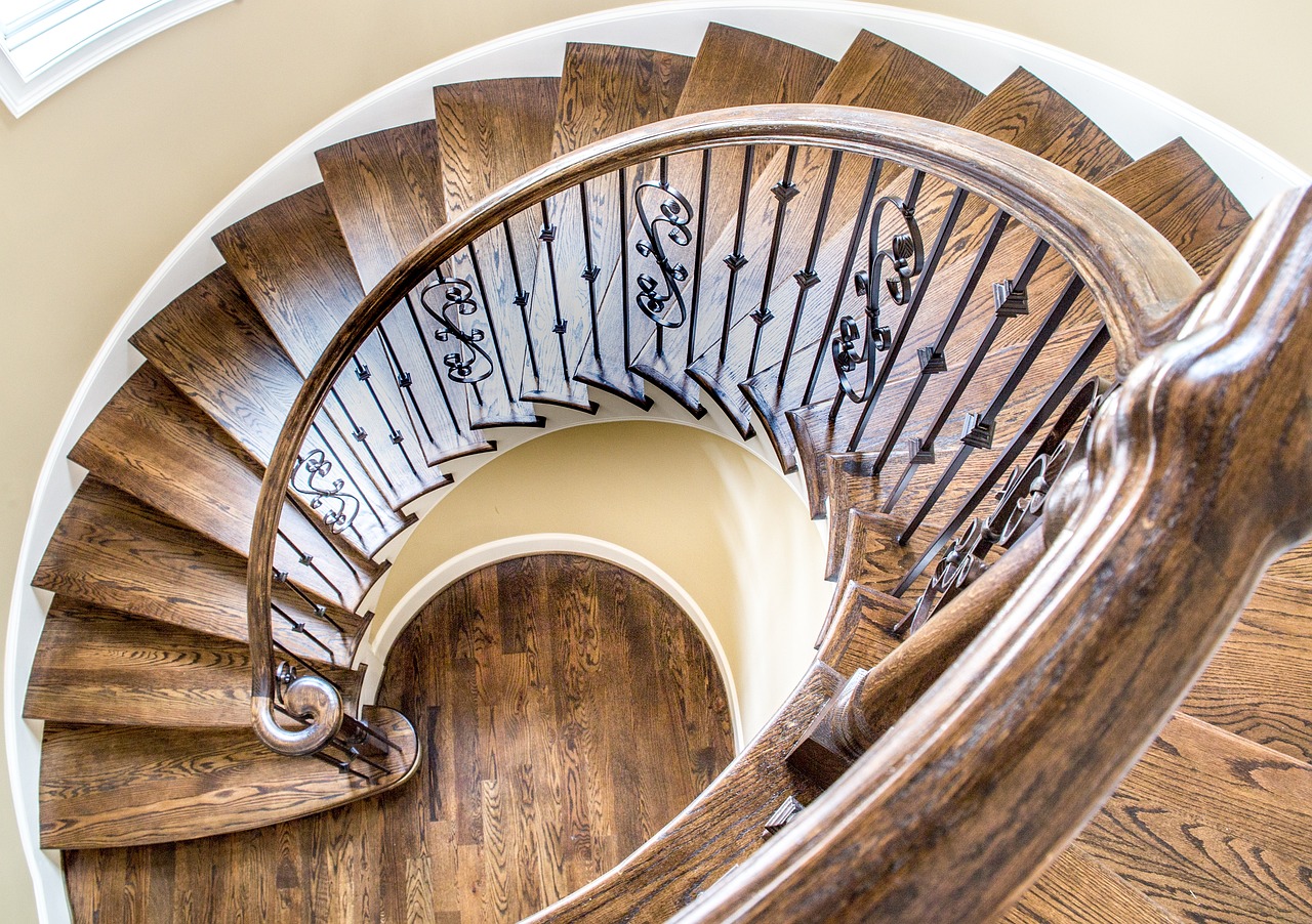 a spiral staircase in a house with wood floors, by Robbie Trevino, baroque, award winning masterpiece, award-winning masterpiece, ornate spiral stairs, john baer