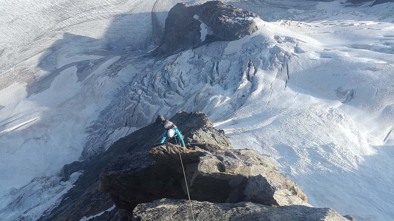 a man standing on top of a snow covered mountain, a picture, by Erwin Bowien, reddit, figuration libre, belaying, girl of the alps, on a rock, genevieve gauckler