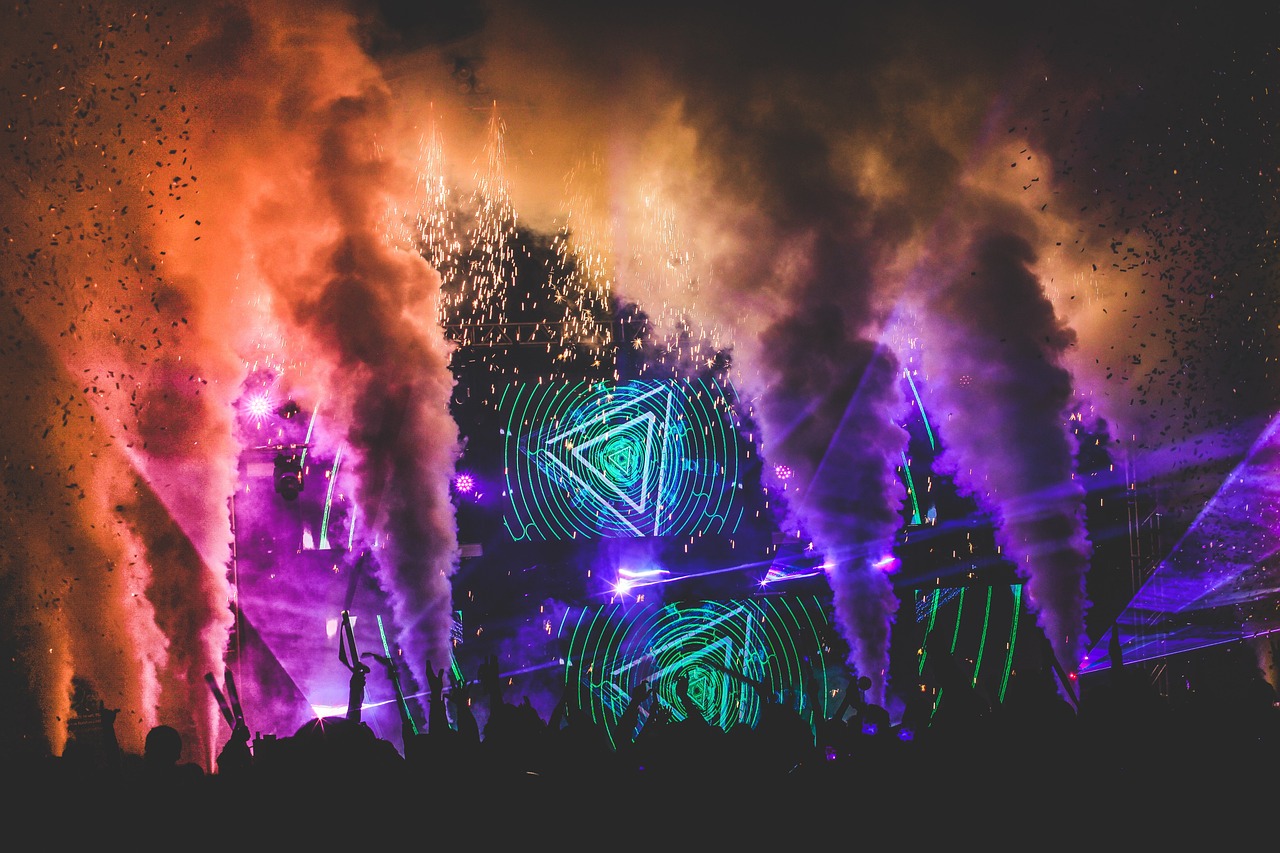 a group of people standing in front of a fireworks display, inspired by Mike Winkelmann, holography, edm fans, triangular elements, music is life, mix between tribal and hi-tech