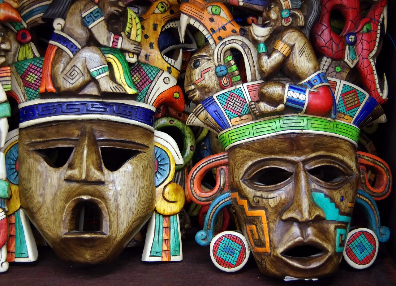 a group of wooden masks sitting on top of a table, by Juan O'Gorman, shutterstock, maximalism, aztec iconography, 4k detail, intense colours, wallpaper - 1 0 2 4