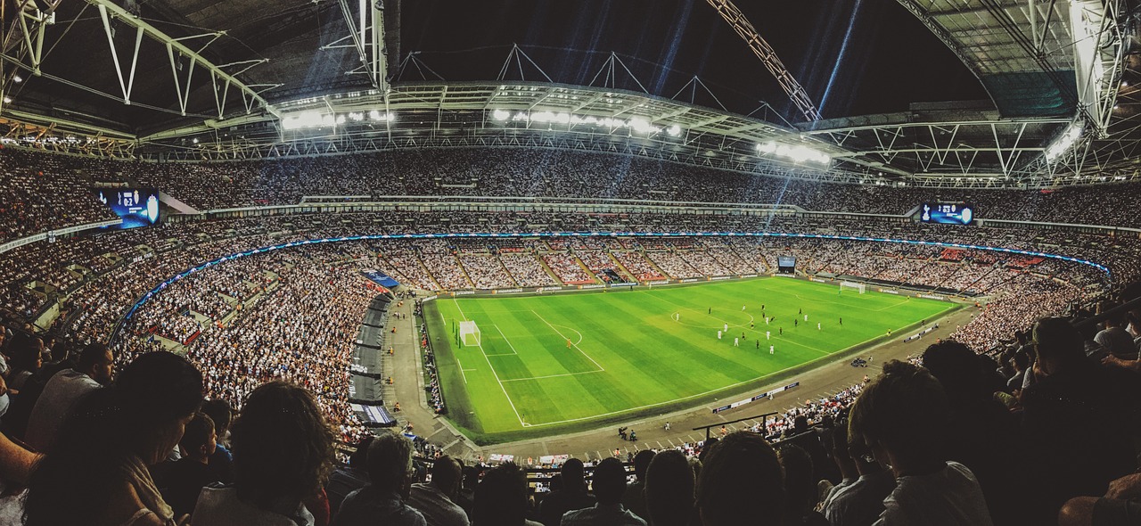 a stadium filled with lots of people watching a soccer game, a picture, pexels contest winner, 😃😀😄☺🙃😉😗, london, instagram photo, intricate sparkling atmosphere