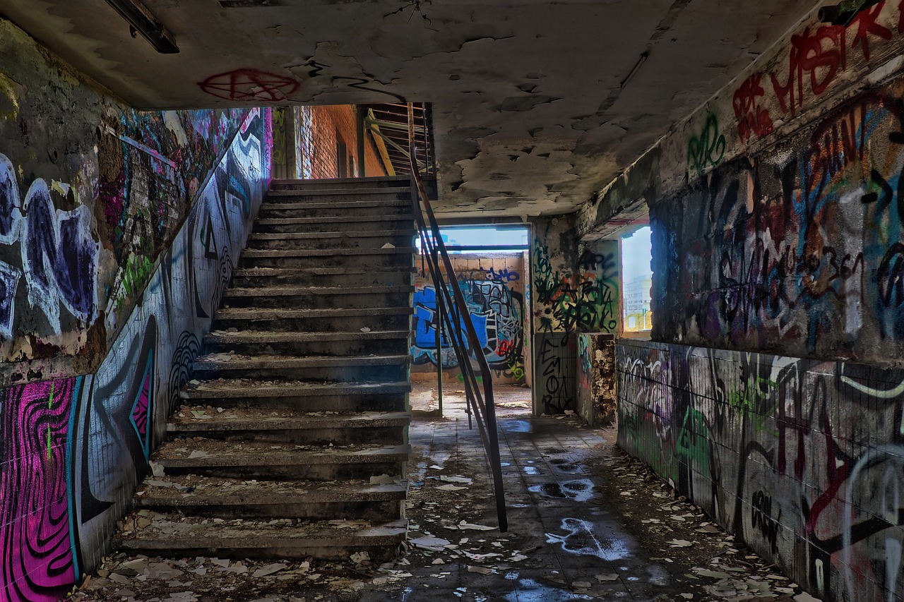 a set of stairs in a run down building covered in graffiti, flickr, hdr photo, last photo, sparsely populated, post apocalyptic theme park