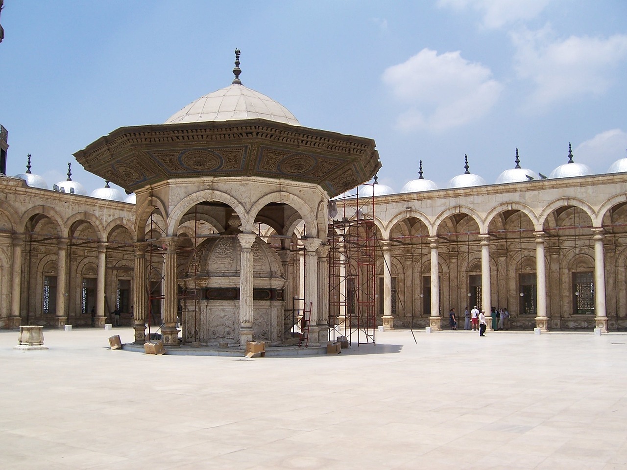 there is a gazebo in the middle of a courtyard, by Ahmed Yacoubi, flickr, with great domes and arches, pedestal, the photo shows a large, restored