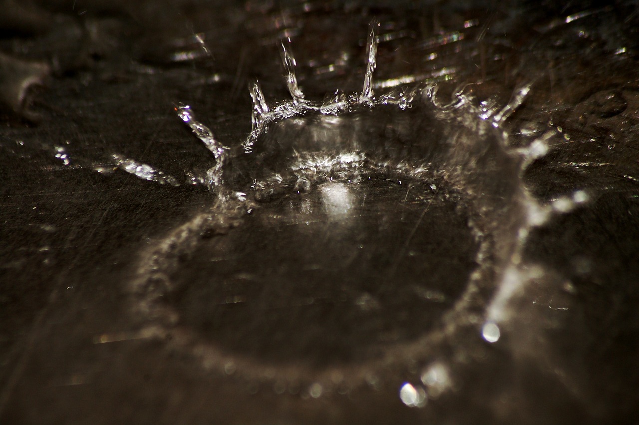 a close up of a sink with water coming out of it, a macro photograph, inspired by Lucio Fontana, flickr, spider web, circle forms, macro bokeh ”, broken glass photo