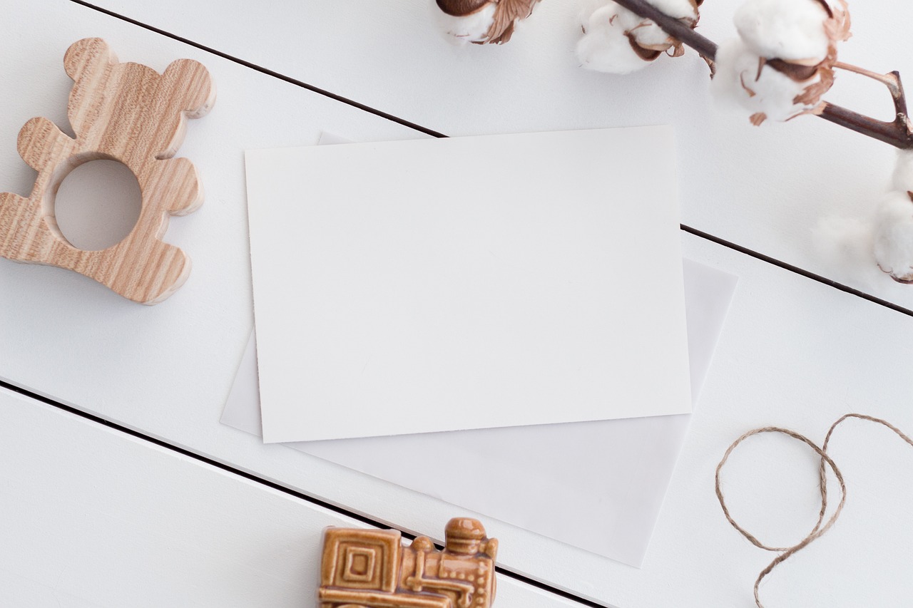 a teddy bear sitting on top of a table next to a piece of paper, a picture, unsplash, full view blank background, card template, white mechanical details, wooden