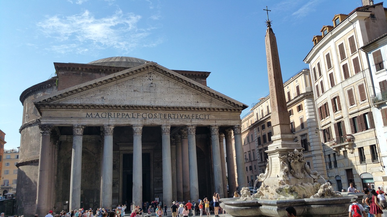 a group of people standing around a fountain in front of a building, a photo, pantheon, rock columns, the neat and dense buildings, marker”