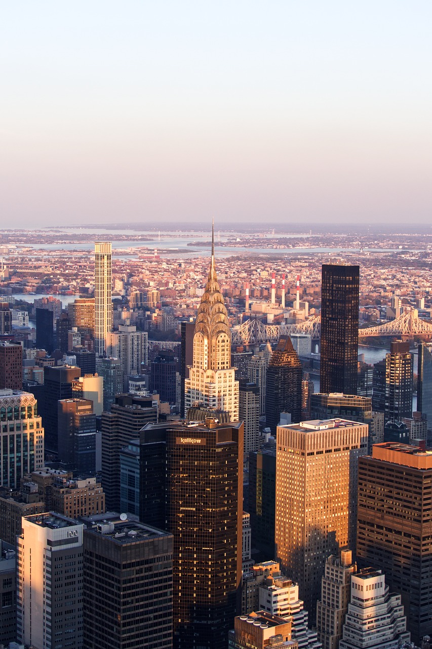 a view of a city from the top of a building, by Robert Jacobsen, shutterstock, chrysler building, shot at golden hour, view from helicopter, 2 0 2 2 photo