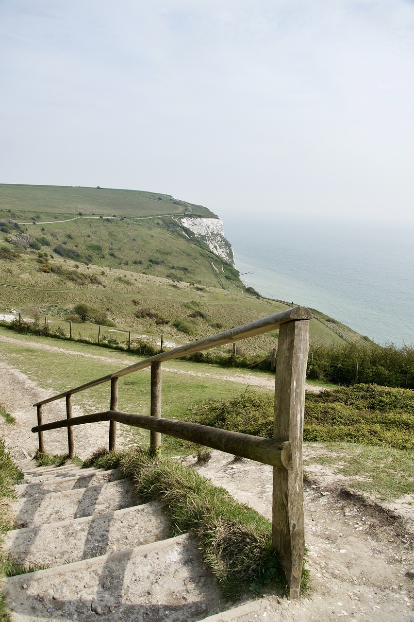 a set of stairs leading to the top of a hill, a stock photo, by Edward Corbett, cliffs of dover, valley in the distance, modern high sharpness photo