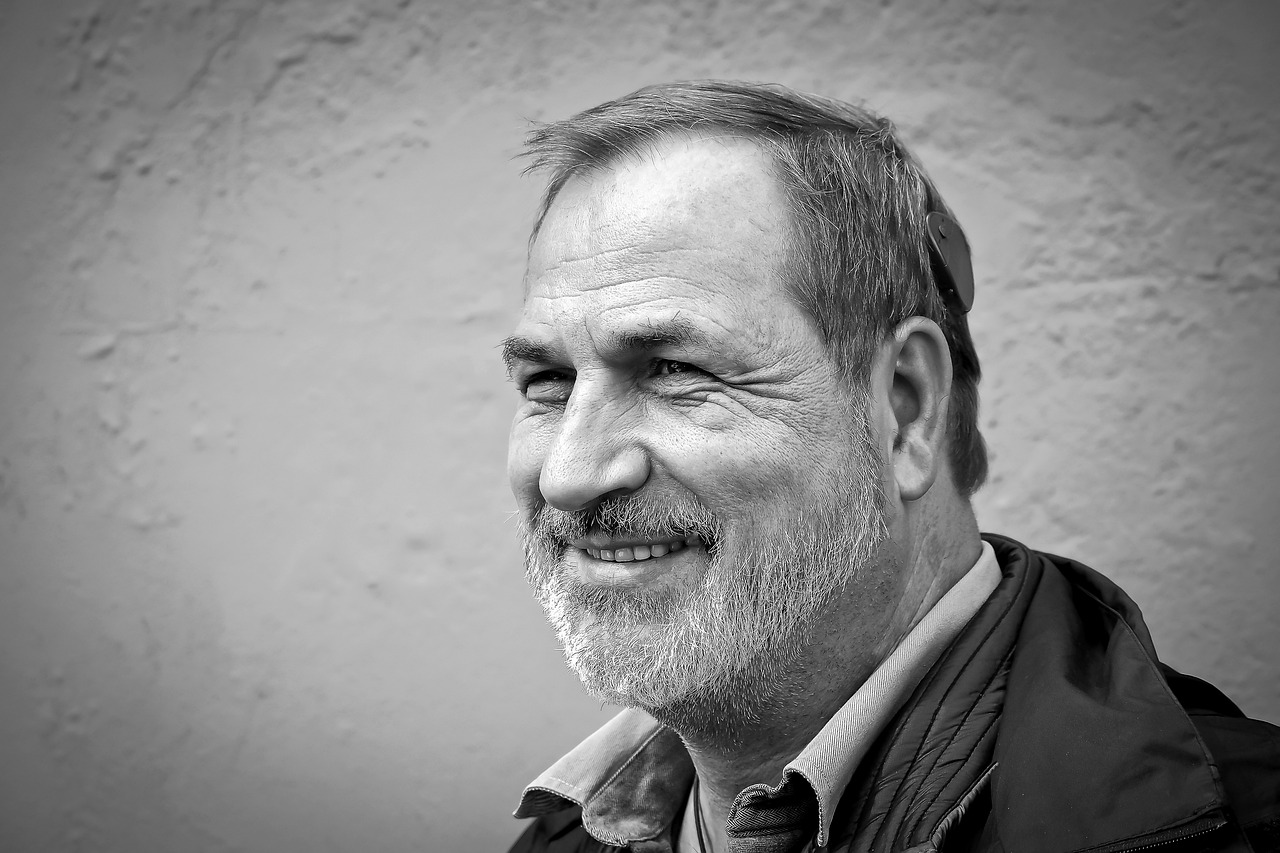 a black and white photo of a man with a beard, a photo, by Hans Schwarz, pixabay contest winner, portrait of a smiling, gary chalk, italo calvino, portrait realistic photograph