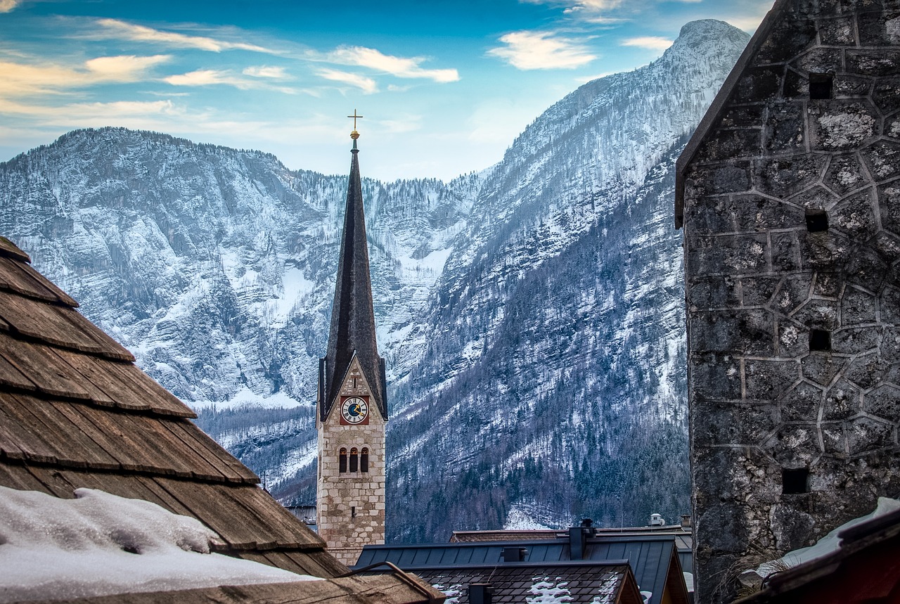 a church steeple with a steeple in the background, a photo, by Franz Hegi, shutterstock, icy mountains, tonemapped, wintry rumpelstiltskin, above view