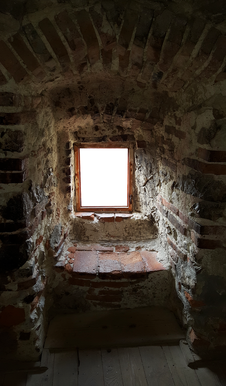 a small window in an old brick building, by Jan Konůpek, pexels, inside a crypt, dramatic view, worm\'s eye view, scarry castle). mystical