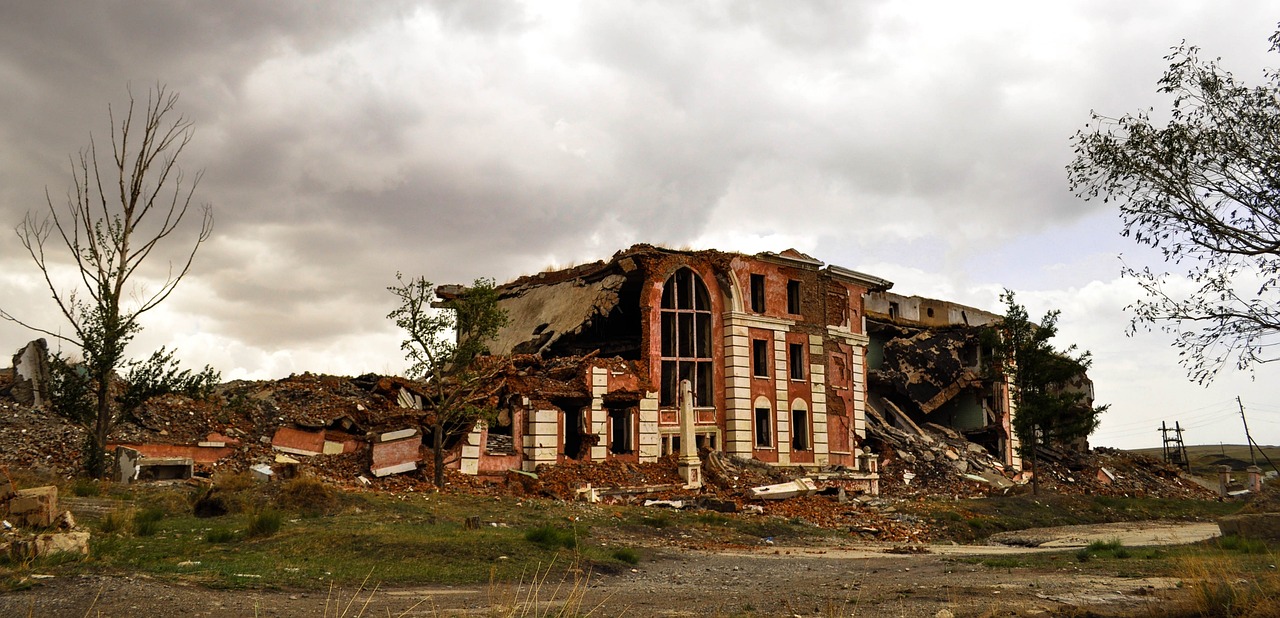 a large brick building sitting in the middle of a field, auto-destructive art, massive destruction, 2 0 1 0 photo, rubble, georgic