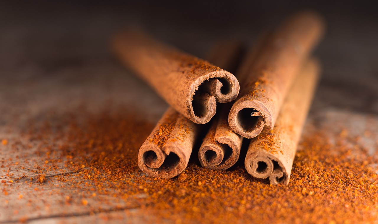 a pile of cinnamon sticks sitting on top of a table, a macro photograph, shutterstock, rust background, pepper, close-up product photo