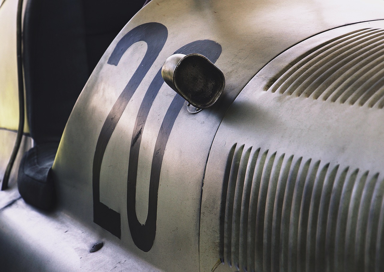 a close up of the front end of a car, a photo, by Hans Schwarz, photorealism, numerical, scratched metal, 2 0, race car