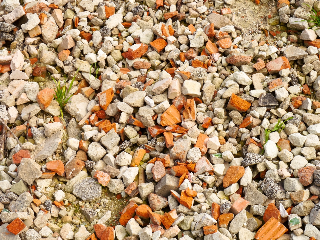 a red and white fire hydrant sitting on top of a pile of rocks, a mosaic, shutterstock, realism, occasional small rubble, panorama, detailed zoom photo, orange rocks