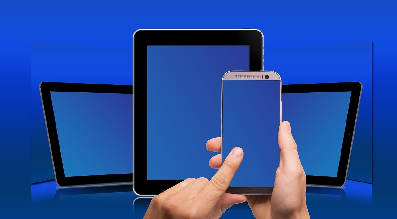a close up of a person holding a cell phone, a picture, computer art, flat panels, solid blue background, different sizes, computers and digital monitors