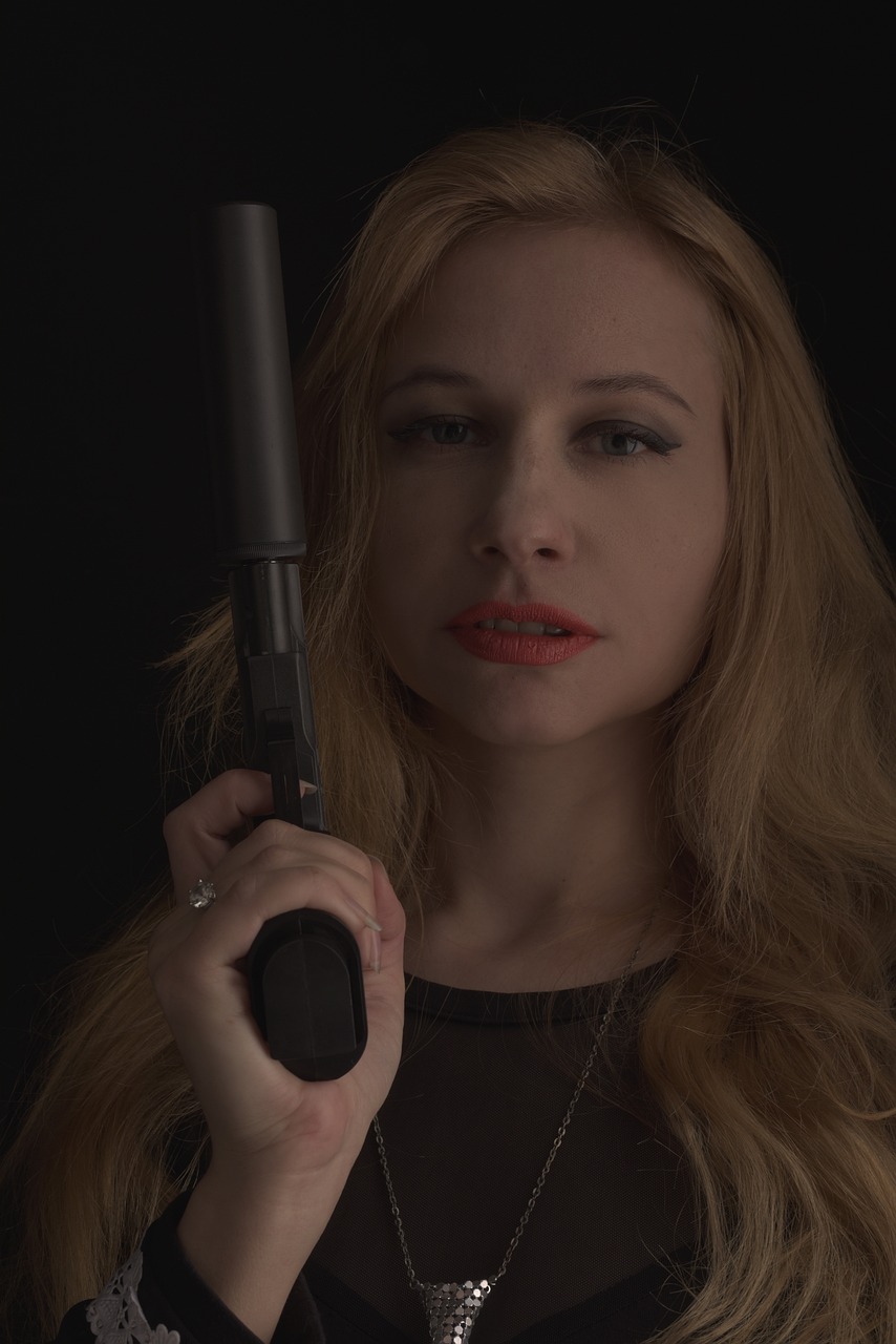 a woman holding a gun in front of her face, a portrait, by Rihard Jakopič, cinestill!!, vampire, britt marling style 3 / 4, b - roll