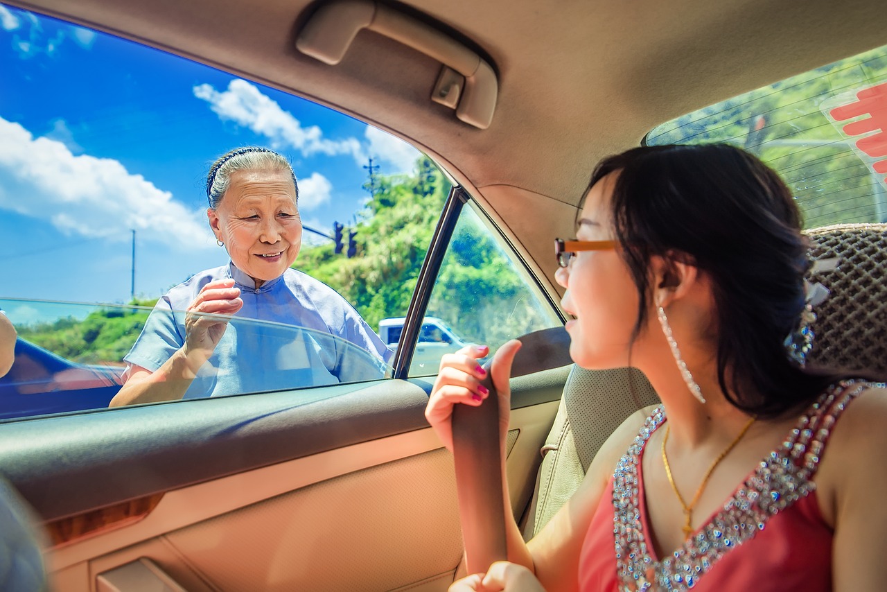 a couple of people that are sitting in a car, a stock photo, by Bernardino Mei, shutterstock, chinese empress, looking in mirror at older self, she is approaching heaven, taiwan