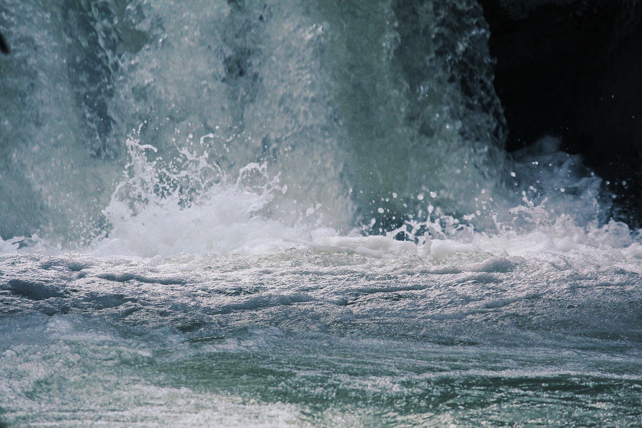 a man riding a wave on top of a surfboard, a picture, pexels, hurufiyya, brutalist waterfall environment, closeup 4k, hd footage, banner