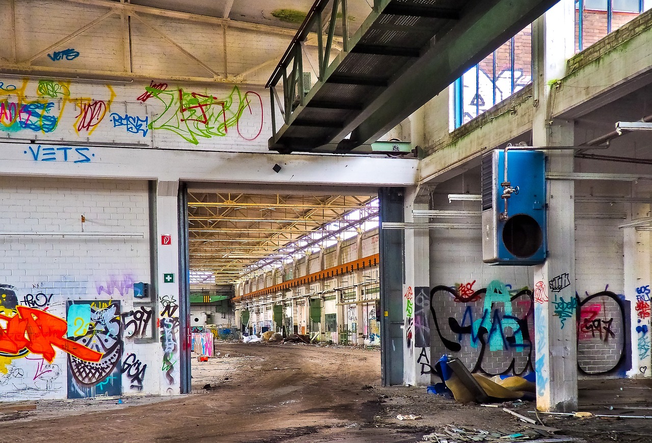 a building with lots of graffiti on the walls, by Richard Carline, urbex, tall factory, fotografia, bizzaro