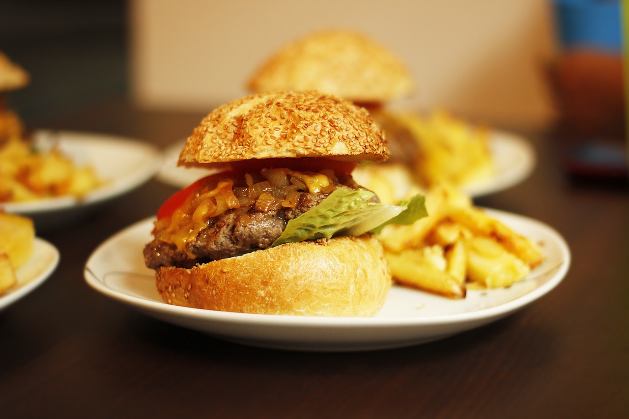 a close up of a plate of food on a table, pixabay, realism, operating on burgers, side profile shot, 4k food photography, handmade